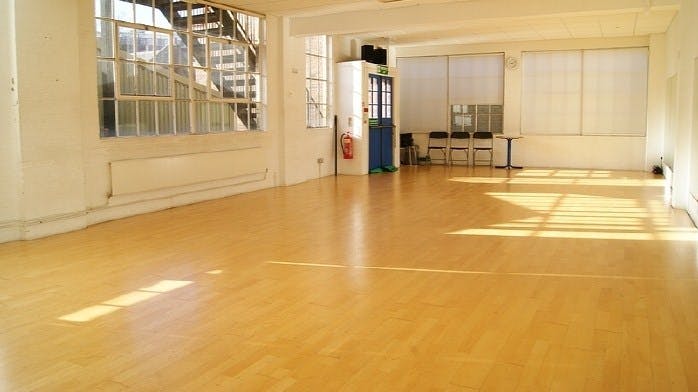 Spacious STUDIO 3 with polished floors, ideal for workshops and networking events.